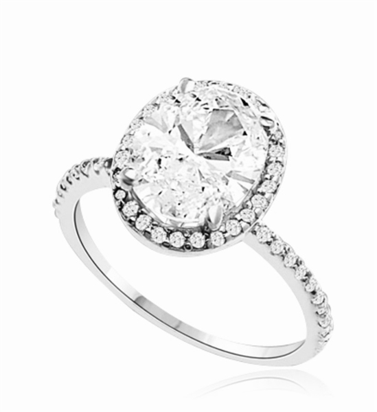 Beautiful Oval Centerpiece, 2.5 cts, is surrounded by Round Brilliant Melee in this elegant engagement ring. The band consists of round pointer melee to form a brilliant radiance. Appx. 3.5 Ct. T.W. In Platinum Plated Sterling Silver.
