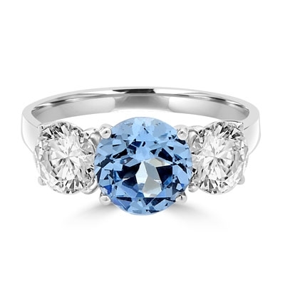 Three stone ring. Diamond Essence 2.0 carat Round Aquamarine stone in the center and 1.0 carat Round Brilliant stones on each side. 4.0 cts.t.w. Platinum Plated Sterling Silver.