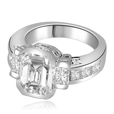 Not for the shy - this exquisite Ring with a 4 Ct. Bezel Set Radiant Emerald Cut Diamond Essence Masterpieces in the center and Princess Cut accents on both sides. 6 Cts. T.W, in Platinum Plated Sterling Silver.
