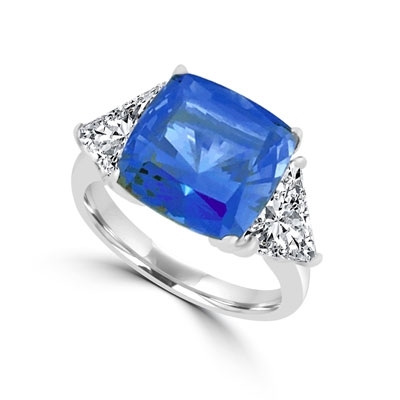 Sapphira - Fantastic Ring with a plush 4 Ct. Cushion Cut Sapphire Essence Masterpiece that highlights by each side of Trilliant accents.6 Cts. t.w. in Platinum Plated Sterling Silver , to chase your blues away!