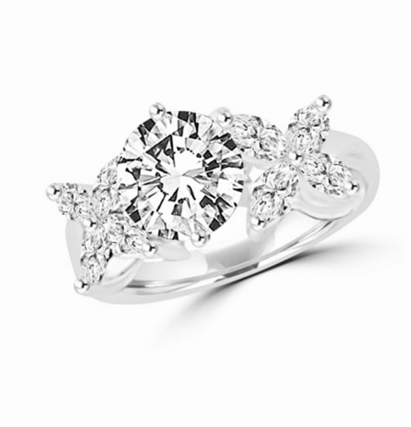 Unusual Ring with a 2.0 Ct. Round Brilliant cut Diamond Essence center stone supported by a vibrant "X" on each side with 8 Marquise Cut Masterpieces. 3.2 Cts. T.W, in Platinium Plated Sterling Silver