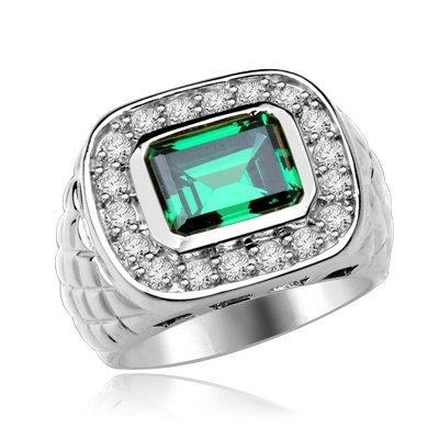 Imposing Platinum Plated Sterling Silver Man's ring with a 4.0 ct. bezel-set Emerald cut Emerald center stone attended by a melee of Round cut mini masterpieces. 4.5 cts. t.w. For prime movers. (Also available in 14K Solid White Gold, Item#WRD4920).