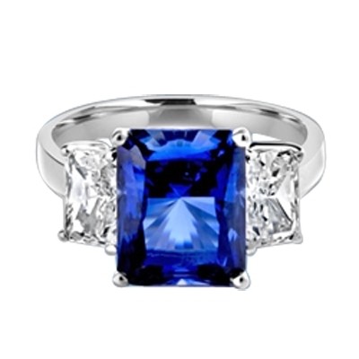 Sapphire Ring - 4.0 Cts. Radiant Emerald cut Saphhire Essence in center accompanied by Radiant Emerald cut Diamond Essence on sides. 5.0 Cts. T.W. set in Platinum Plated Sterling Silver.