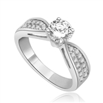 Sexy and Stylish 0.75 Ct. Round Stone Ring with deep channel set round accents on the band. 1.25 Cts. T.W. In Platinum Plated Silver.