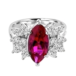 Designer Ring with 2.0 Cts. Marquise cut Ruby Essence in center accompanied by delicately set Marquise and Melee on each side. 3.0 Cts. T. W. set in Platinum Plated Sterling Silver.