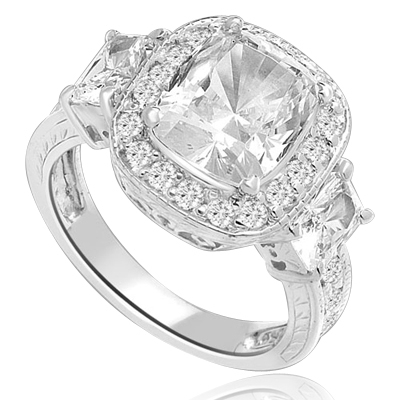 A 4 Ct Sparkling Ring with Radiant Emerald Cut is adorned by Brilliance on all sides of Round Accents and smaller Radiant Emerald on band. A stupendous 6.5 Cts. T.W. In Platinum Plated Sterling Silver.