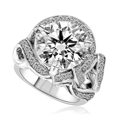 Outstanding - 8.5 Cts. Round Brilliant Diamond Essence shinning in center surrounded by Melee in curvy setting. Perfect for any Occasion!! 9.5 Cts. T.W. set in Platinum Plated Sterling Silver.