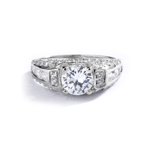 Engagement Ring- 1.0 Ct. round Brilliant Diamond Essence in center with Chanel set Baguettes and Melee going half way down the band. 2.0 Cts. T.W. set in Platinum Plated Sterling Silver.