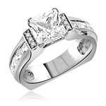 Designer Ring with 2.0 Cts. Princess Cut Diamond Essence in center and baguettes and melee on sides set in Platinum Plated Sterling Silver. Available in select Ring sizes.