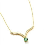 Supreme Necklace that is sure shot eye candy! 2.0 Cts. Round Emerald Essence Dangler atones a curvy melee of Round Brilliants set exquisitely in an Art Deco Setting! 3.50 Cts.T.W. attached with Chain in Platinum Plated Sterling Silver.