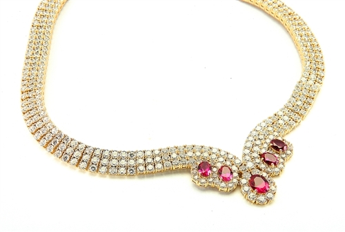 Magnificent Ruby Necklace. 3.0 Cts. Oval cut Ruby Essence in the center and 1.50 Cts. each Ruby Essence encircled by Diamond Essence stones. making 3 rows all around neckline. Special lock- on clasp to secure it. Just perfect to make any day a special day