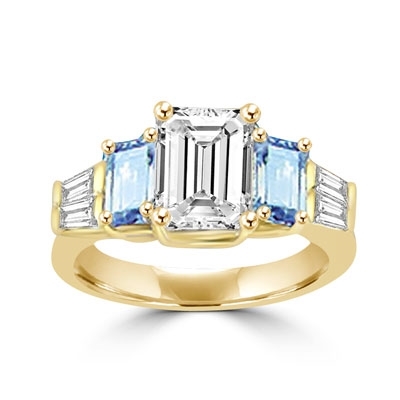 Classic Wide Ring with a 2 Ct. Emerald Cut Brilliant Masterpiece in the center, saluted on each side by a 0.5 ct. Emerald Cut Aquamarine Stone and clear white Baguette Masterpieces further down. 3.5 Cts. T.W, in Gold Vermeil.