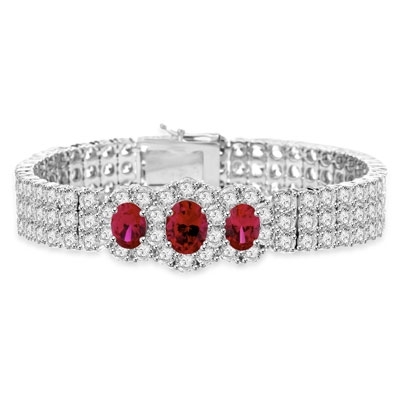7" long Diamond Essence Bracelet with 2.0 Ct. Ruby in center and 1.0 Ct. Ruby on each side encircled by Diamond Essence stones making 3 rows all around wrist. Appx. 40.0 Cts. T.W. set in 14K Solid White Gold.