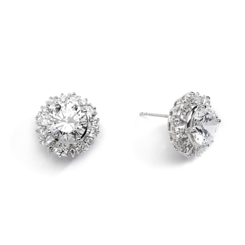 Designer Earrings With Round Brilliant Diamond essence in center surrounded by alternately set Princess and melee. 14.5 Cts T.W. set in 14K White Gold.