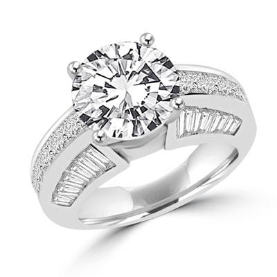 Diamond Essence Designer Ring with 3.50 Cts. Round Brilliant Center, set off by Chanel set Princess stones and Tapered Baguettes on either side.5.50 Cts.T.W. set in 14K Solid White Gold.