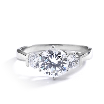 14K Solid White Gold ring features a 2.0 ct. round cut Diamond Essence centerpiece rubbing elbows with two 0.3 round cut masterpices beside it. 2.6 cts. T.W. Breeding shows.