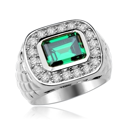 Imposing 14K Solid Whit Gold, Man's ring with a 4.0 ct. bezel-set Emerald cut Emerald center stone attended by a melee of Round cut mini masterpieces. 4.5 cts. t.w. For prime movers.