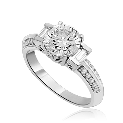 You will surly be pleased with this stunning new design. 2 Ct. Round Brilliant Diamond Essence Masterpiece is accentuated by channel baguettes and round melee on band. Ethnic carving on band makes this a uniquely adorable piece to collect. 2.75 Cts. T.W.