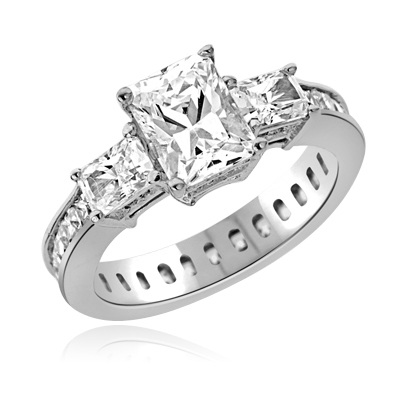 Diamond Essence Ring with Radient Emerald Center Followed by Princess cut Stones And Round Brilliant Melee on the band, 4.50 Cts.T.W. set in 14K White Gold.