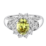 Floral Ring - 1.25 Cts. Oval cut Peridot Essence set in center with Round brilliant Diamond Essence on top and bottom and cluster of Melee, making floral design, on either side of band. 2.0 Cts. T.W. set in 14K Solid White Gold.