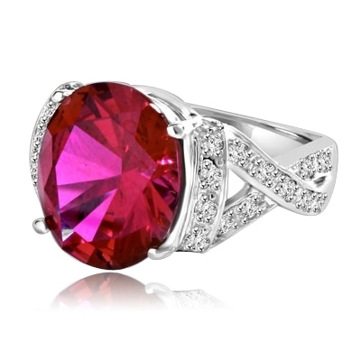 Ruby Ring- 6.0 Cts Oval Cut Ruby Essence in center accompanied by Melee on the band making criss cross design. 6.50 Cts. T.W. set in 14K Solid White Gold.