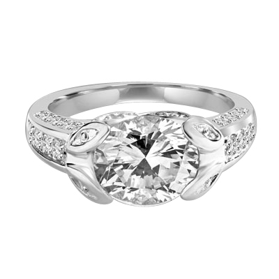 Designer Ring with 3.0 Cts. Round Brilliant Diamond Essence, artistically set in leaf shaped prongs in center, set off by Melee on either side of the band. 4.0 Cts. T.W. set in 14K Solid White Gold.