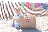 Molly Sims wearing neon tote bag on the beach