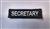 Secretary 3"x3/4" White on Black