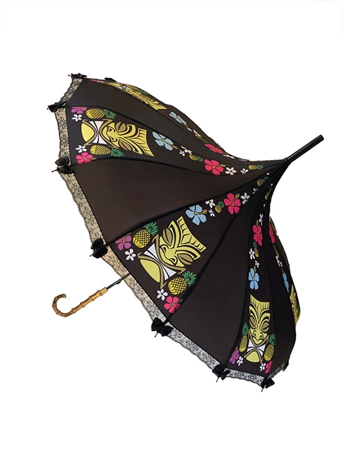 This beautiful black umbrella Hilary's Vanity has a Colorful Tiki pattern with pineapples on to top. It features lace and bow details with a real Bamboo hook style handle.