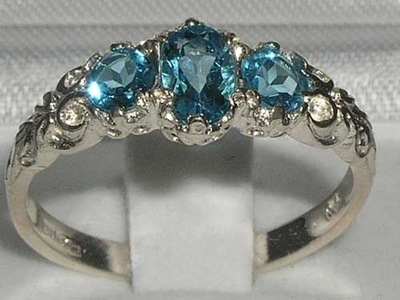 Elegant 10K White Gold Blue Topaz Trilogy Ring