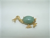 14k yellow gold duck pin with a jade