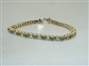 Diamond and emerald tennis bracelet 14k yellow gold