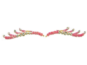 Pink sequins and decorations with white crystals in the perfect shape to use as eye liner or eye brows.