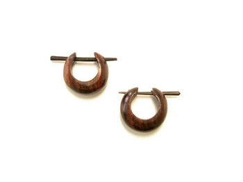 Small fat hoop earrings in dark wood use a pin to pierce the ear.