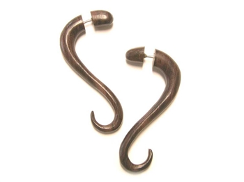 Two inch long fake gauges in a soft snake-like drop in wood.