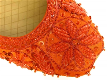 Bright orange silk shoes with matching beads and sequins.