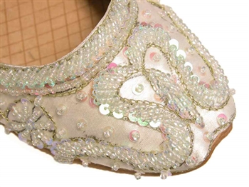 Indian shoes in warm white ivory silk with iridescent beads and sequins with gold threadwork.