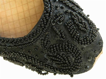 Rich black silk with matching beads and sequins cover these beautiful shoes.