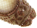 Brown silk covered with beads and sequins and matching threadwork in traditional Indian shoes.