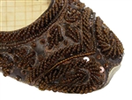 Dark brown silk covered with beads and sequins and matching threadwork in traditional Indian shoes.