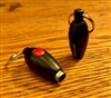 small, football shaped, black punch cutter with a red button