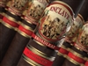 Pictured is a cigar with a band that has a horse and an indian on it, also has a red and gold band under it
