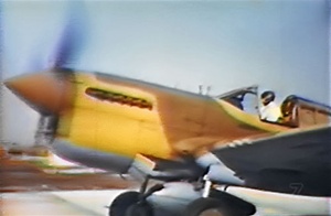 World War 2 color photo of Curtiss P-40 Warhawk taking off from the film Ways of the Warhawk.