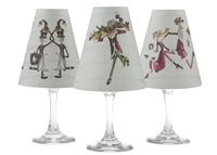Set of 6 coordinating elf, snowmen, and Mr. and Mrs. Claus pattern translucent paper white wine glass shades by di Potter.  Made in the USA