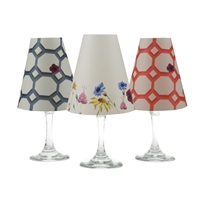 Set of 6 coordinating roses, leaves and zinnias pattern translucent paper white wine glass shades by di Potter.  Simple add a tea light to a wine glass to create simple table decor.  Made in the USA