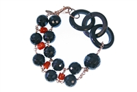 Round faceted Black Onyx Gemstones are accented by Red Coral Nuggets. A single large Onyx bead and three links of natural Black Horn create an asymmetrical look. 925 Rose Gold plated Sterling Silver Chain & Lobster Clasp. 7 1/2" in Length adjustable to 7"