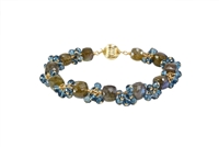 Hand Crafted, this Bracelet features uniquely cut "Cubed" Labradorite Gemstones, alternating with clusters of brilliant, faceted, London Blue Topaz Gemstones. These two Gemstones compliment each other  perfectly. Gold Filled Sterling Chain & Latch.