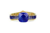 Ziio's small Armonia Tennis Bracelet features a large Lapis Gemstone at the center with Blue Quartz Gemstones on the band. Gold Murano Glass seed Beads outline the band. 925 Sterling Silver Button Closure, adjustable in length.