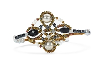Ziio's small Knott Bracelet with Black Onyx & Tourmaline Gemstones, Mother of Pearl and White Seed Pearls. Also accented with Silver Beads and Murano Glass Seed Beads. 925 Sterling Silver Button Closure, adjustable in length.