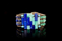 Slices of Blue Lapis mixed with Green Chrysophrase create a checkerboard pattern at the center of this Cuff Bracelet. Enhanced with Peridot & Tourguoise Gemstones & Pyrite Beads the design is created using Murano Beads on Stainless Steel wire.